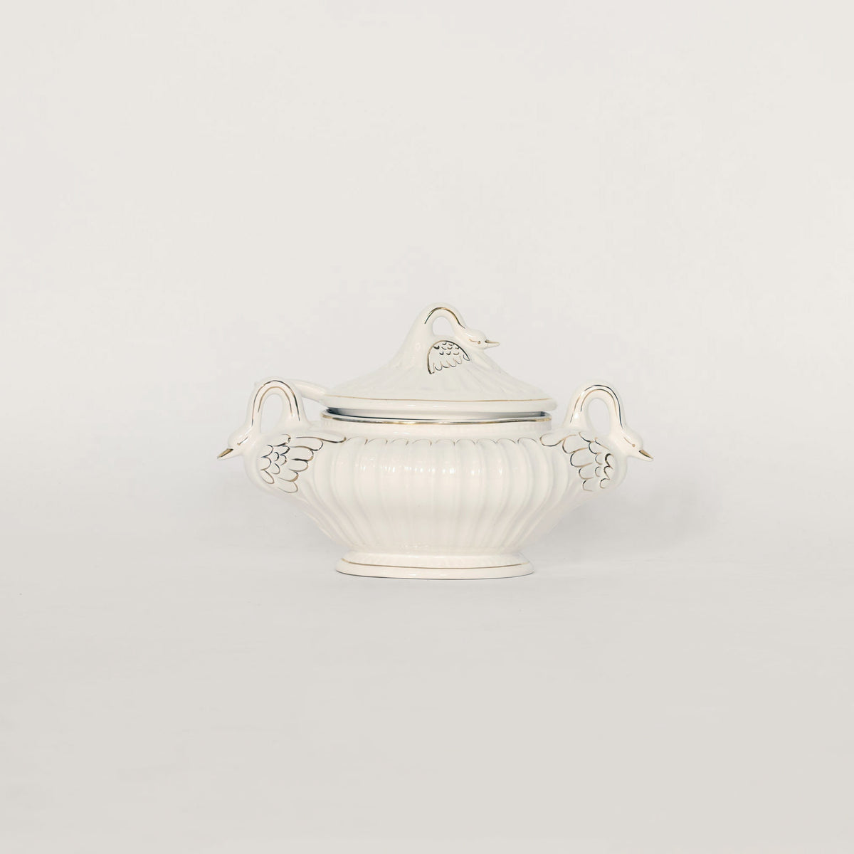 White & gold trimmed decorative bowl with handles on a light gray background