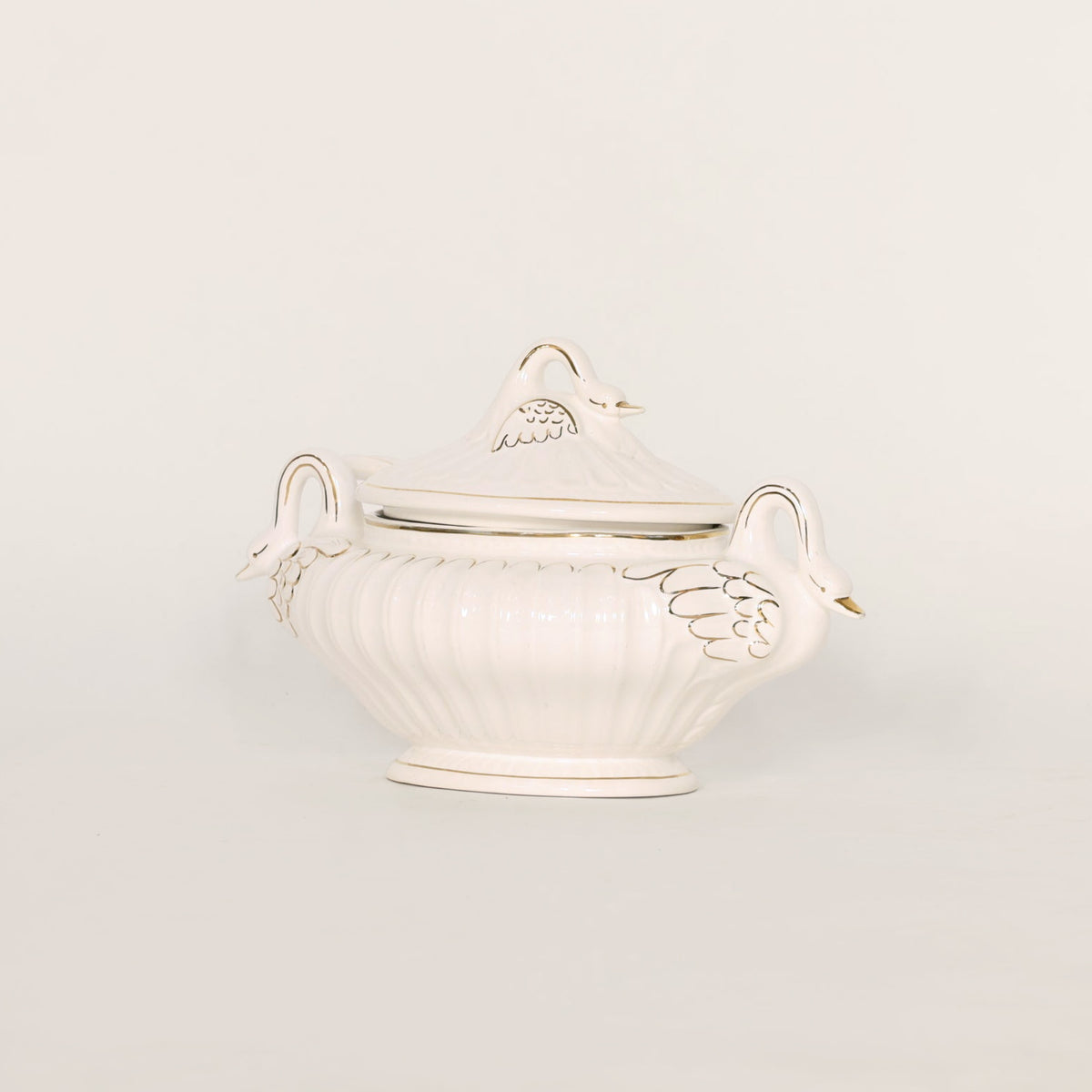 White ceramic tureen with lid on a light gray background