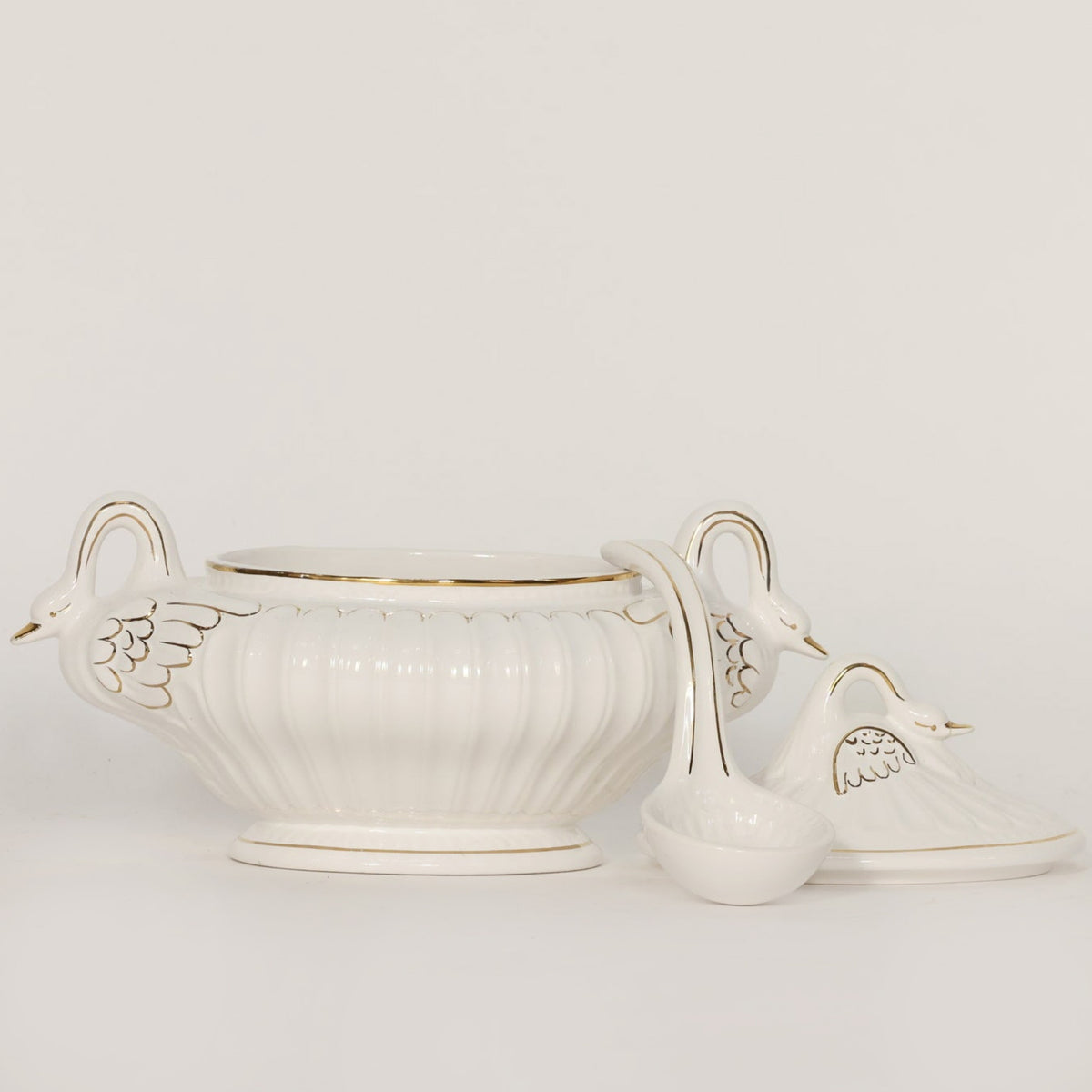 White ceramic tureen with decorative lid on a light gray background