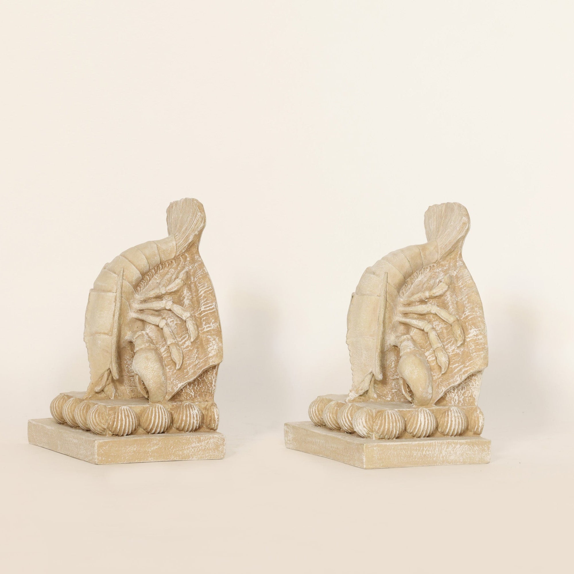 2 Coastal Lobster Sculptural Bookends on beige background.