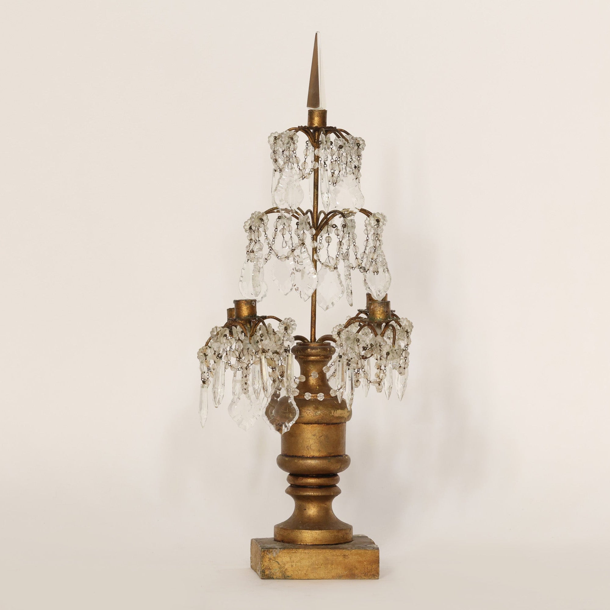 Vintage-style candelabra with crystal accents on a plain background