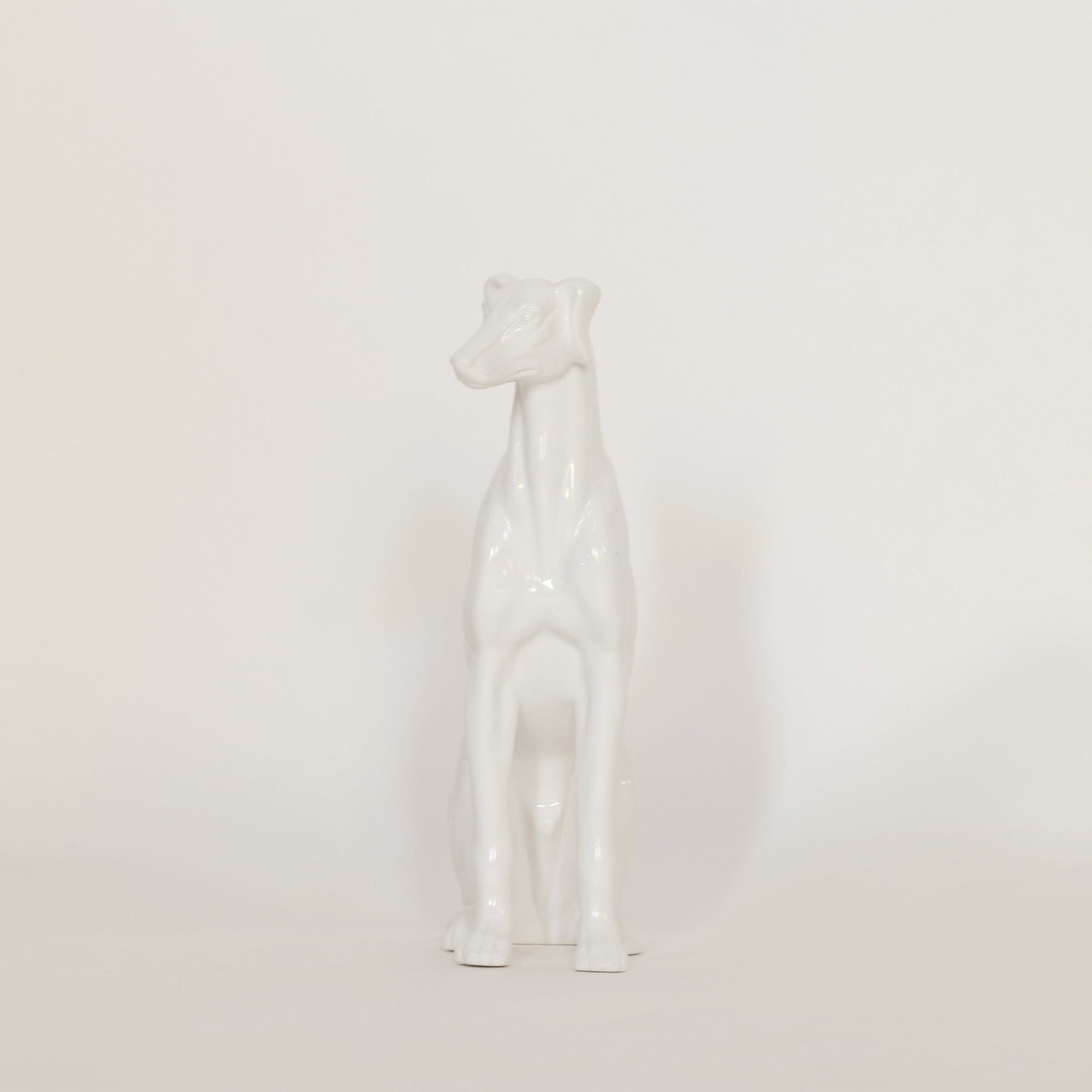 vintage white ceramic dog sculpture on white background.