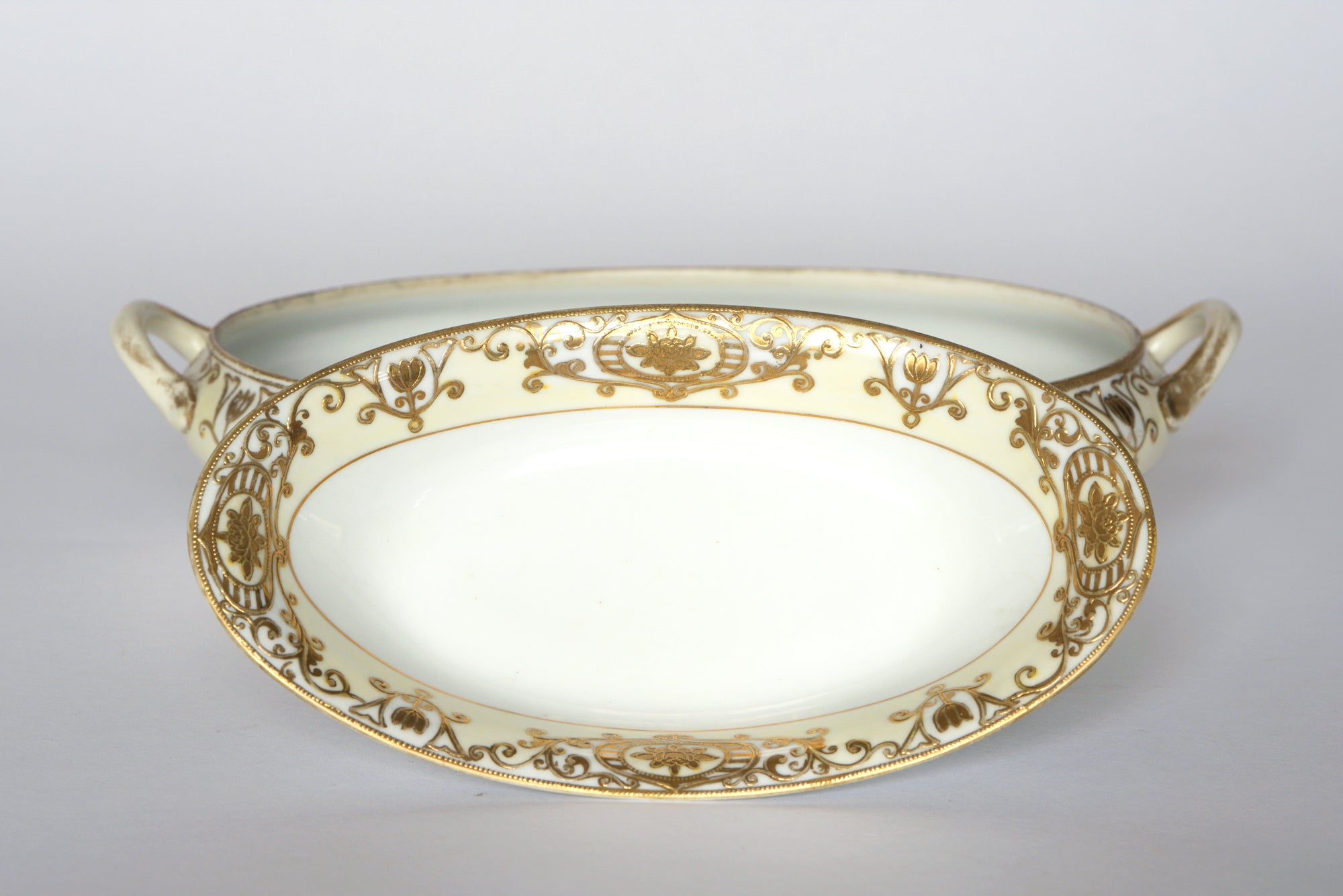 A set of two elegant Euro Trash Noritake vintage porcelain serving bowls, each with handles and detailed gold floral scrollwork—an exquisite addition to any decorative china collection.