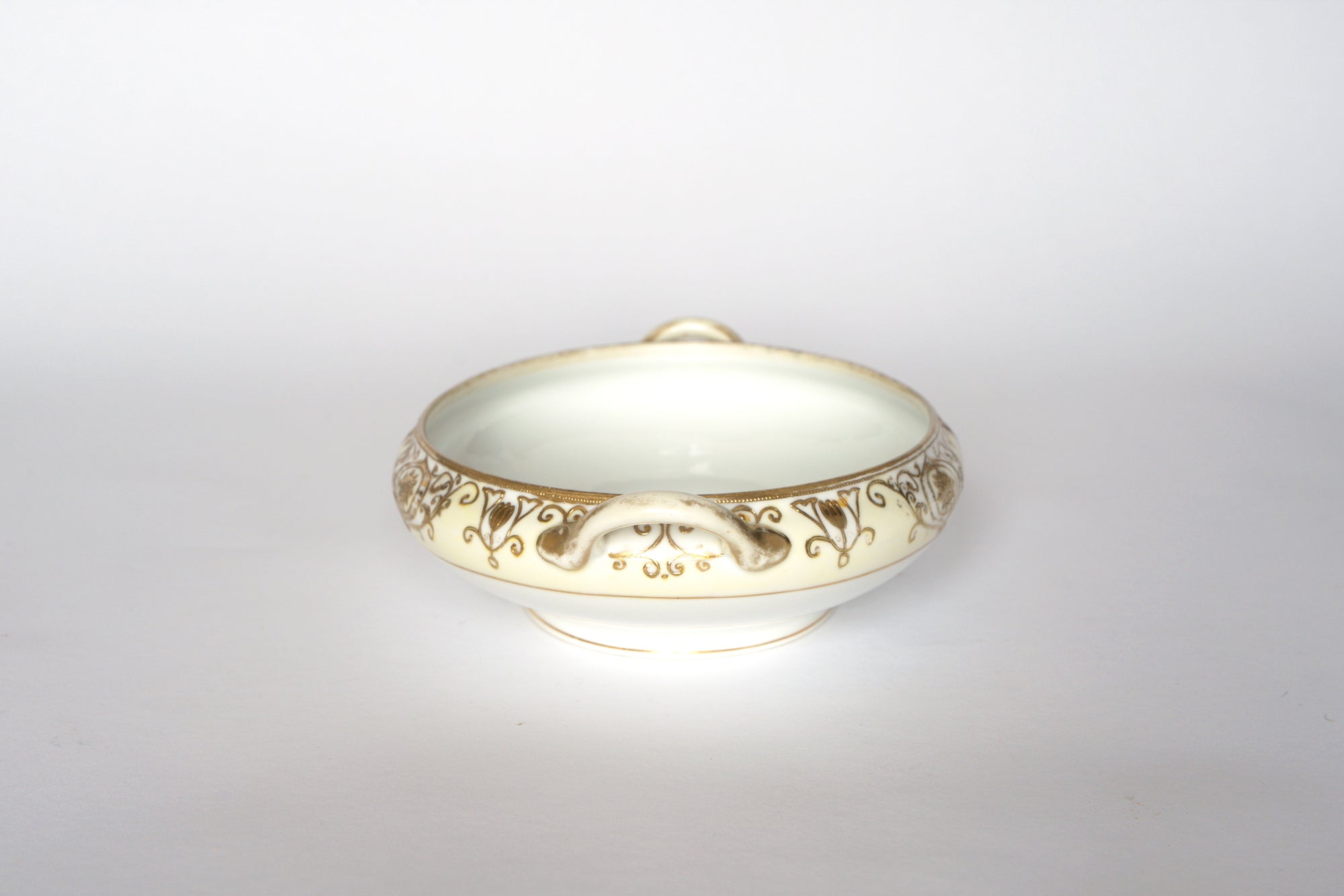 Set of two Euro Trash Noritake vintage porcelain serving bowls, each shallow, round, and white with ornate gold rim designs and small decorative handles—perfect for any china collection. Displayed on a white background.