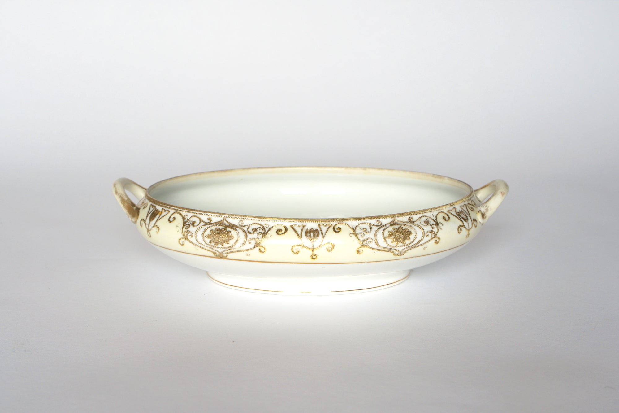 Two Noritake Vintage Porcelain Serving Bowls by Euro Trash featuring shallow, round shapes, two small handles each, and gold and brown rim patterns—ideal for any decorative china collection. Set against a plain white background.