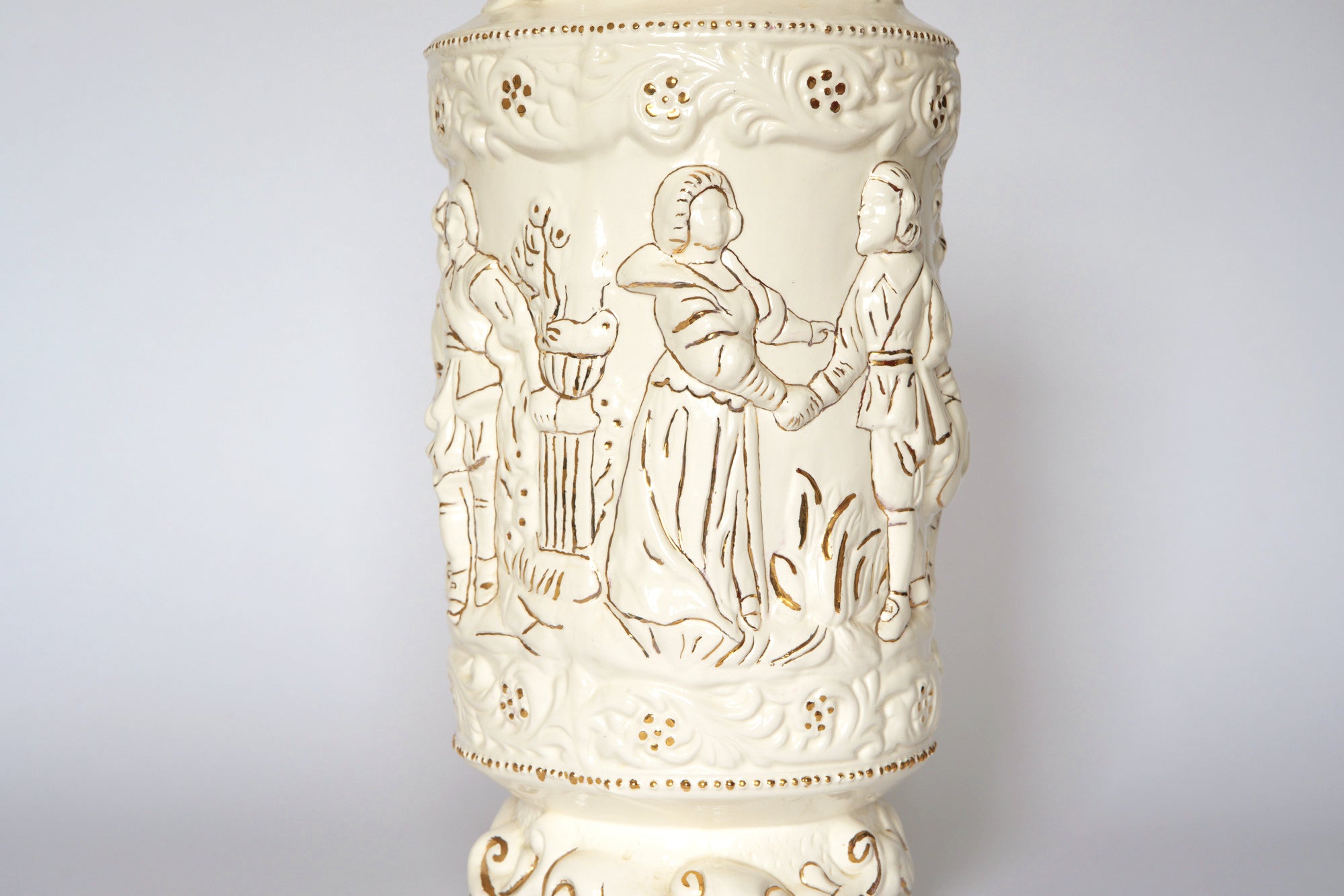 The Euro Trash Vintage Figural Porcelain Vase features people in traditional clothing among decorative patterns and foliage on a white background.