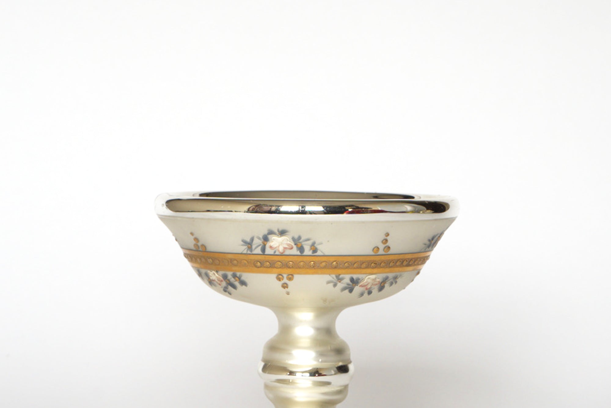 A close-up of the Euro Trash Vintage Hand-Painted Mercury Glass Compote, featuring decorative details and a gold rim, set against a plain white background.