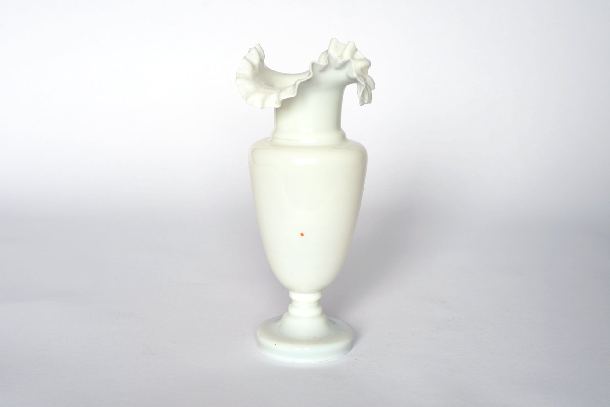 The Euro Trash Vintage Hand-Painted Milk Glass Vase features a ruffled, fluted rim and stands upright on a small round base against a plain white background.