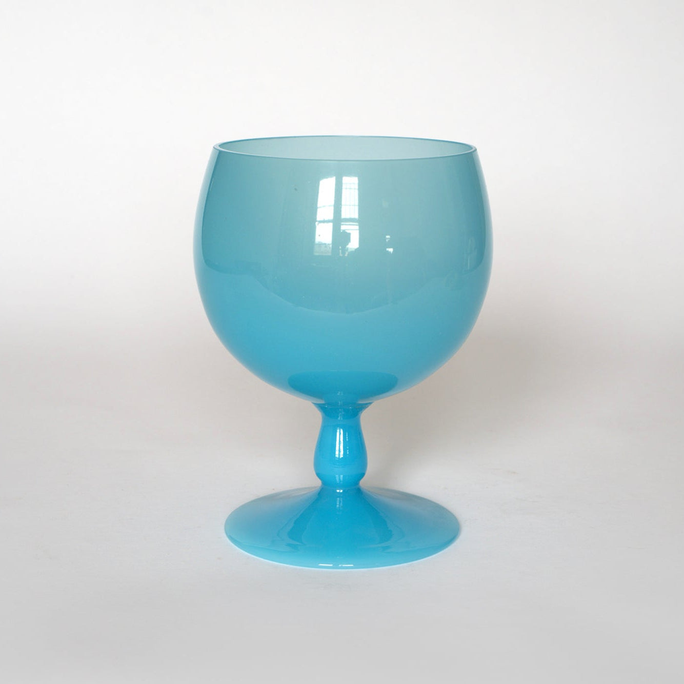 The Euro Trash Vintage Blue Opaline Murano Glass Goblet features a large, round design with a short stem and wide base, shown against a plain white background.