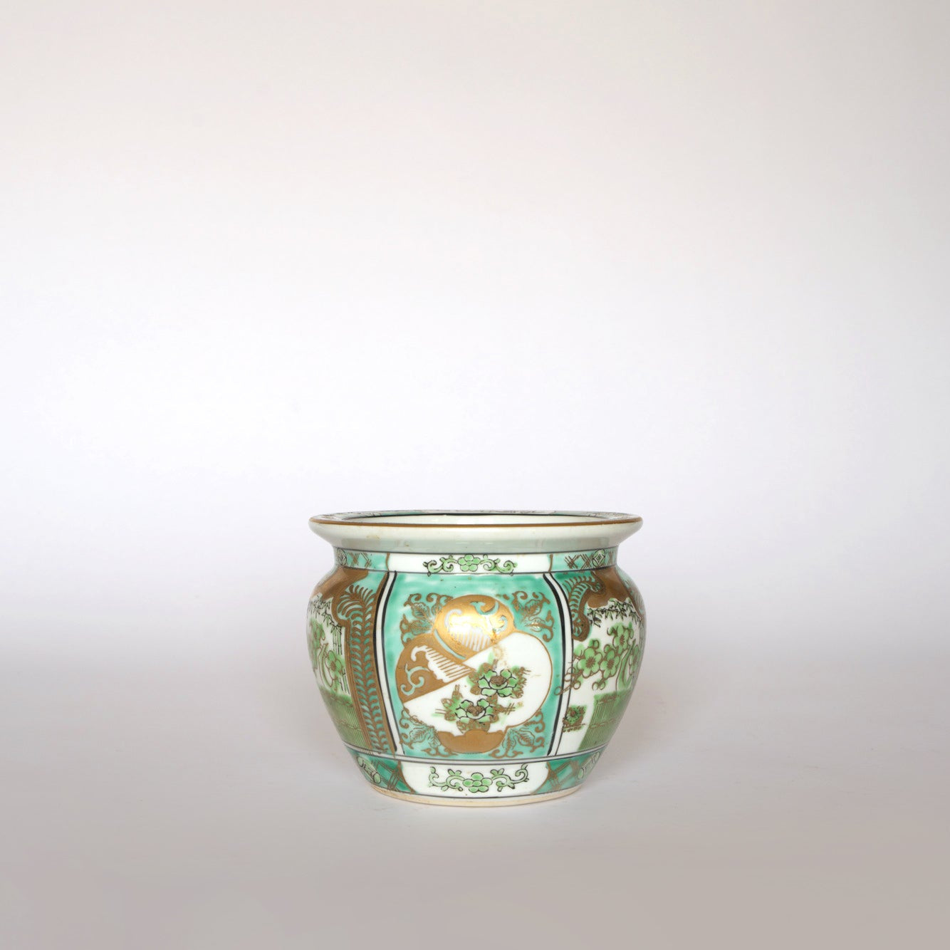 The Euro Trash Vintage Green and Gold Asian Motif Porcelain Cachepot features a wide opening and floral designs in green, gold, and white on a light background, inspired by classic Asian patterns.