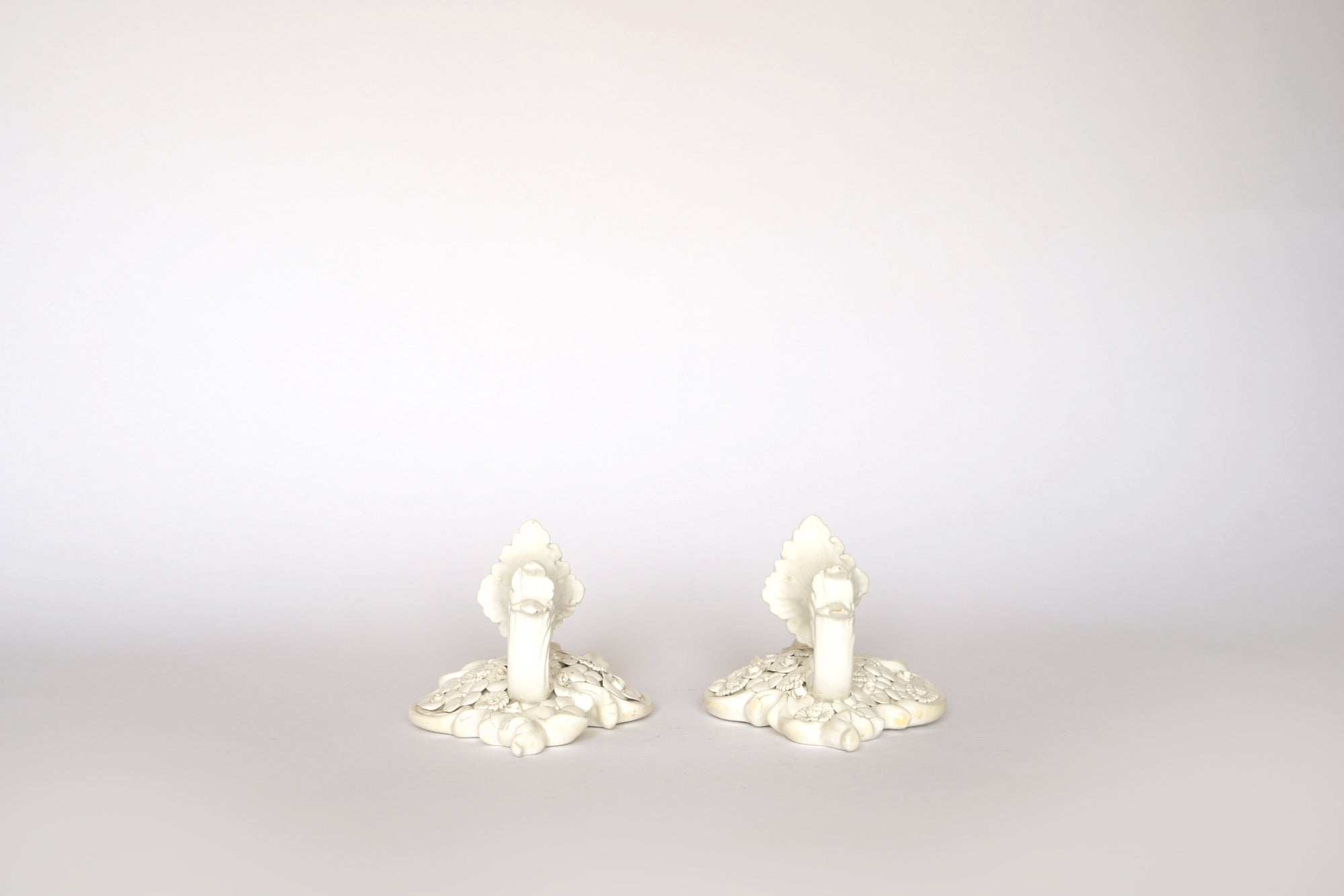 A pair of Euro Trash Porcelain Floral Wall Pocket Vases are displayed side by side on a plain, light background, highlighting the vintage elegance of these decorative wall accents.