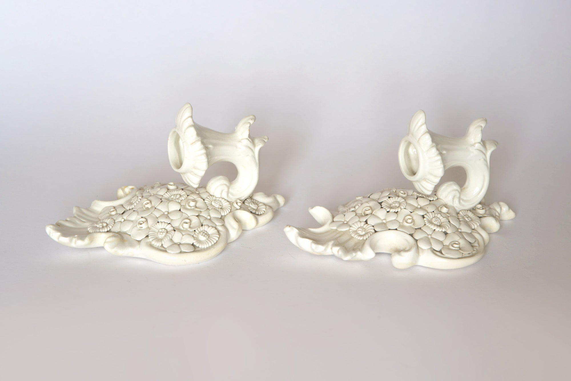 Pair of Euro Trash Porcelain Floral Wall Pocket Vases: two ornate white ceramic fish-shaped vases with floral patterns, vintage-inspired decorative pieces set against a plain white background.