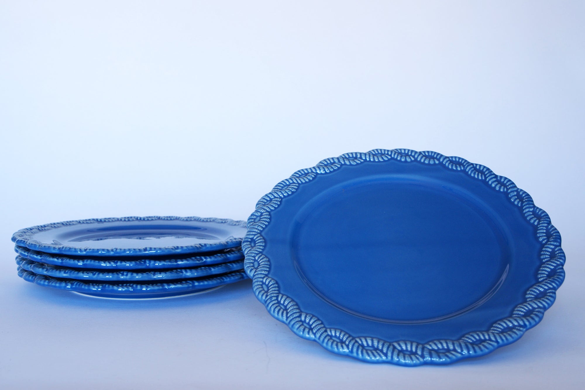 Six Euro Trash Vintage Blue Rim Dinner Plates with Beaded Edge are shown against a light background, with five stacked and one upright to highlight the elegant beaded rim of this stylish dinnerware set.