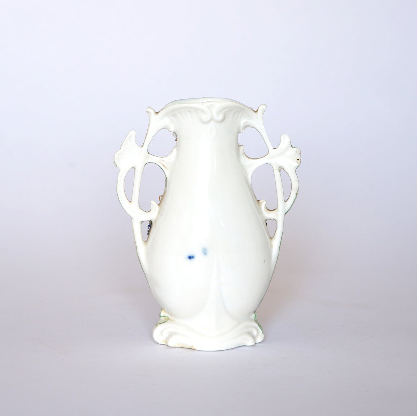 The Euro Trash Vintage Blue & Gold Porcelain Trinket Dish, with ornate design and two decorative handles, features a glossy white finish and subtle blue details, evoking a classic vintage style against a plain white background.