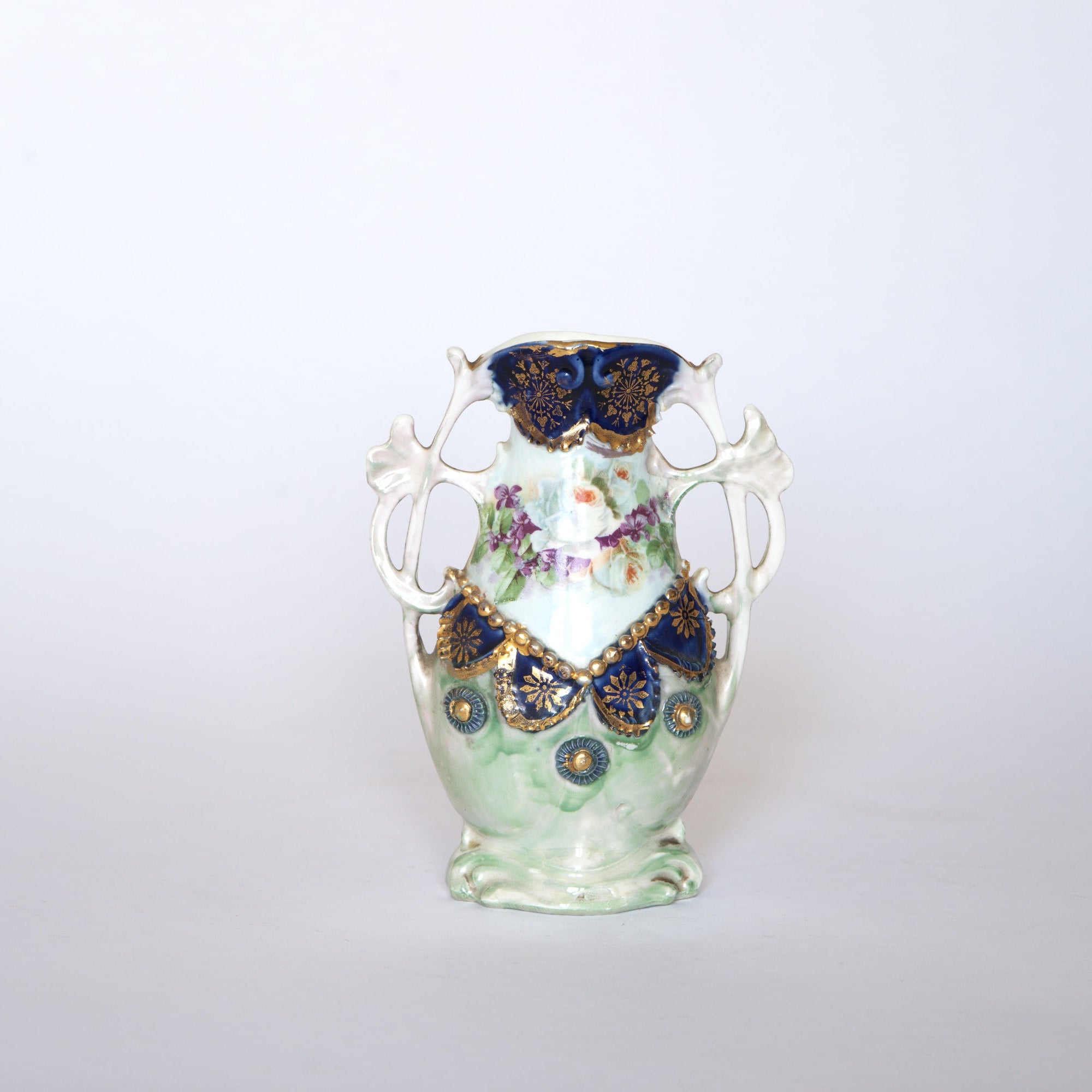 Euro Trash Vintage Blue & Gold Porcelain Trinket Dish features floral patterns, cobalt blue and gold accents, and two decorative handles, displayed on a plain white background.