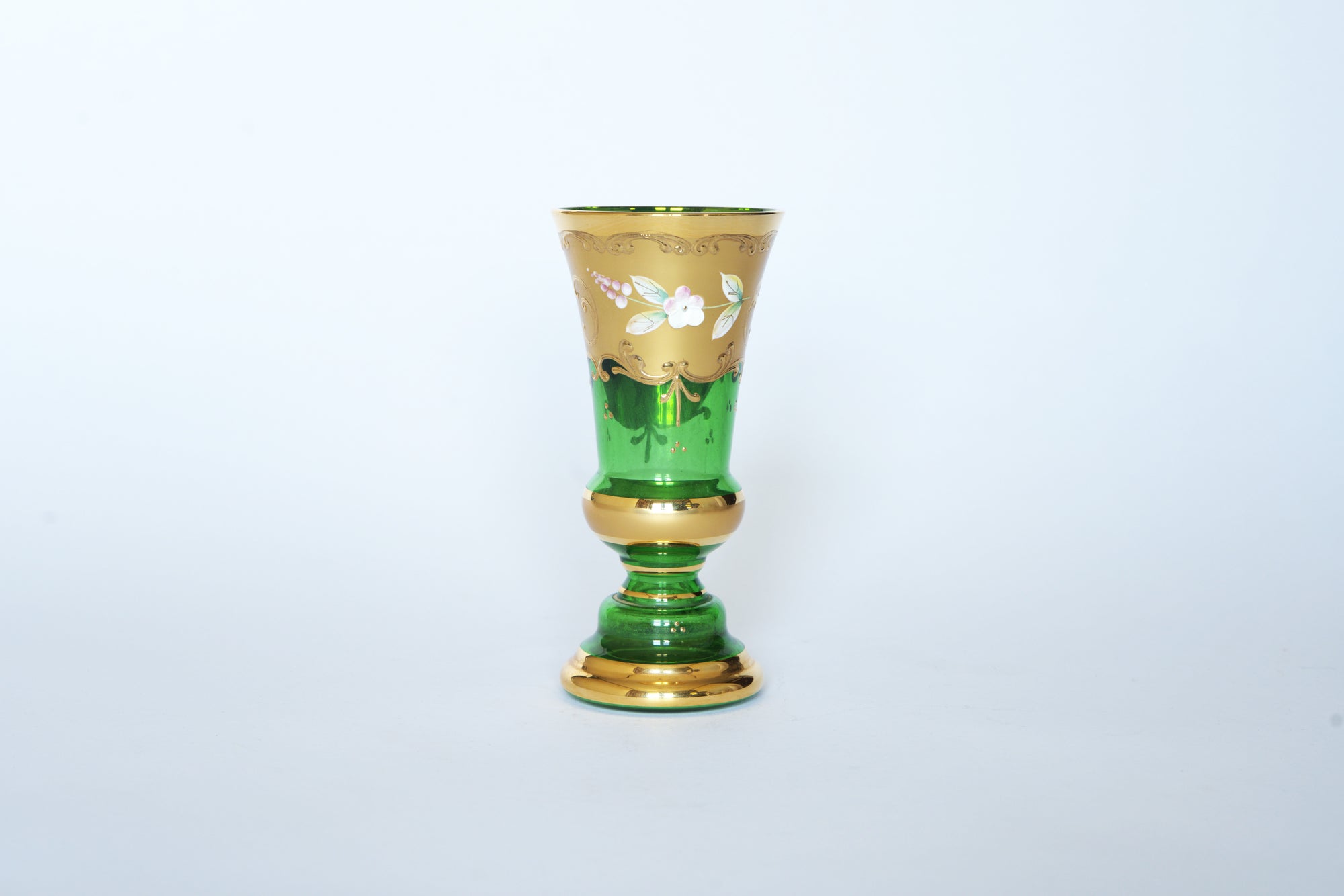 The Euro Trash Vintage Green & Gold Hand-Painted Floral Glass Vase features elegant gold accents and white floral designs, making it a stunning centerpiece for any décor.