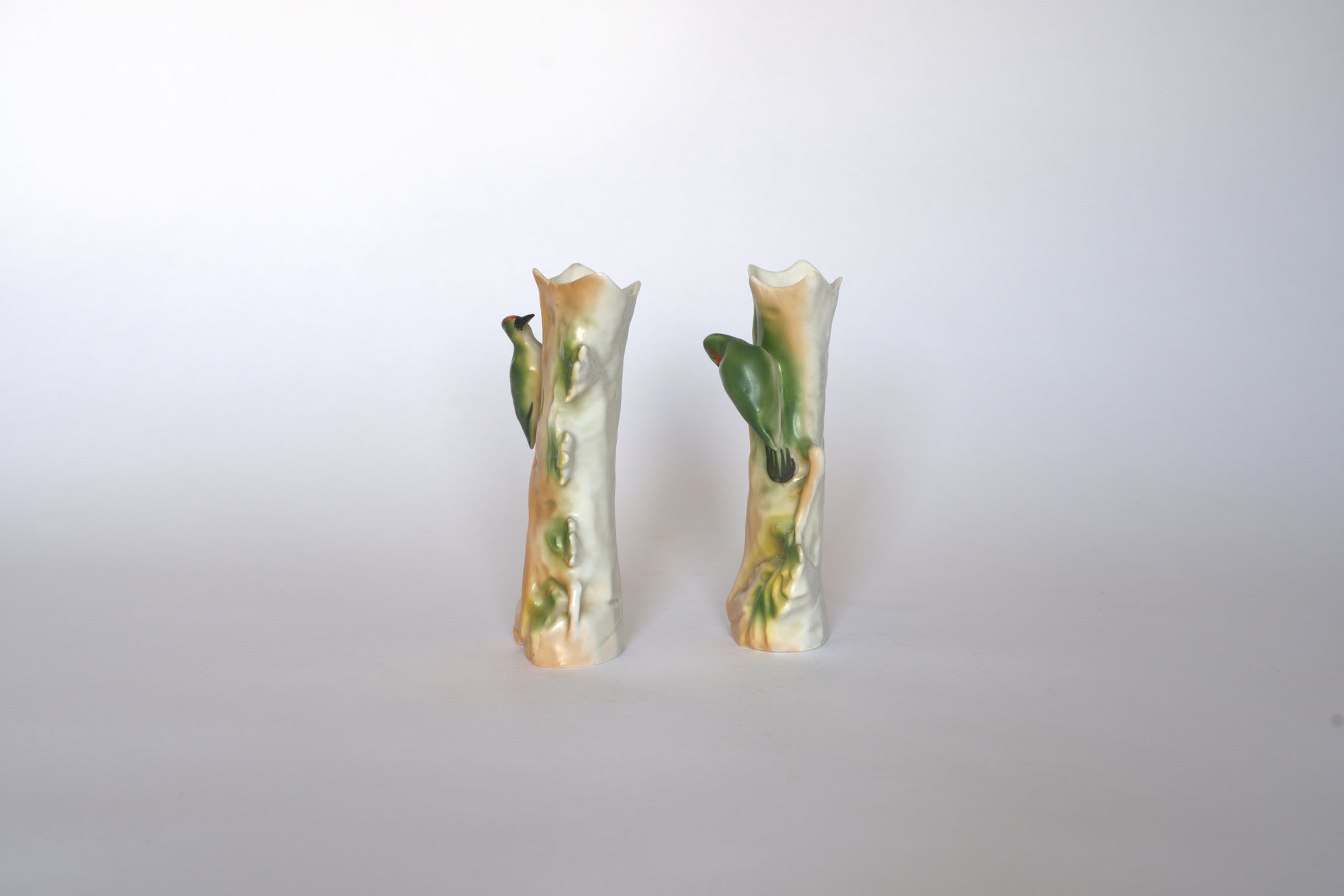 The Euro Trash Pair of Vintage Ceramic Hand-Painted Bird Vases stand side by side against a white background, bringing a charming cottage aesthetic to any space.