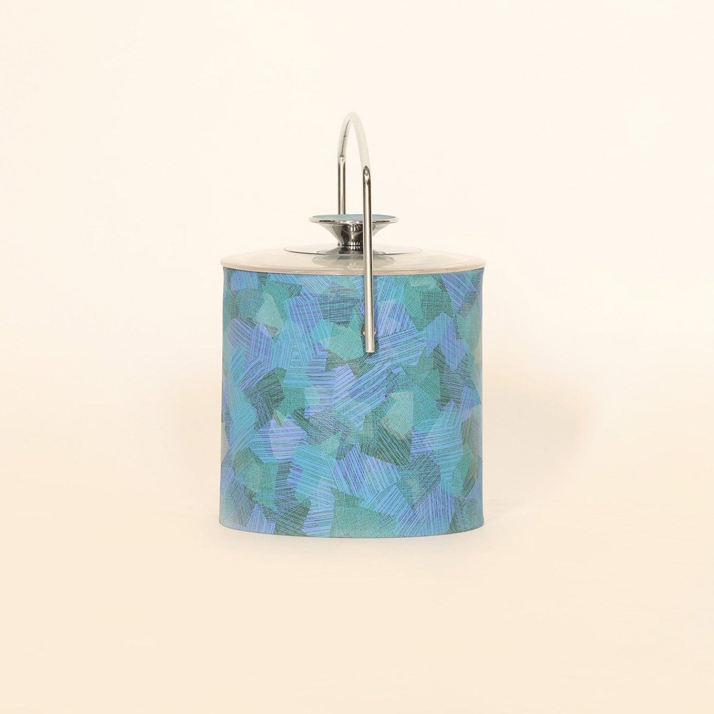 The Mid Century Blue Lucite Ice Bucket by Euro Trash Annie features a blue and green abstract pattern, silver lid, handle, and ice tongs—perfect for adding modern style to your space.