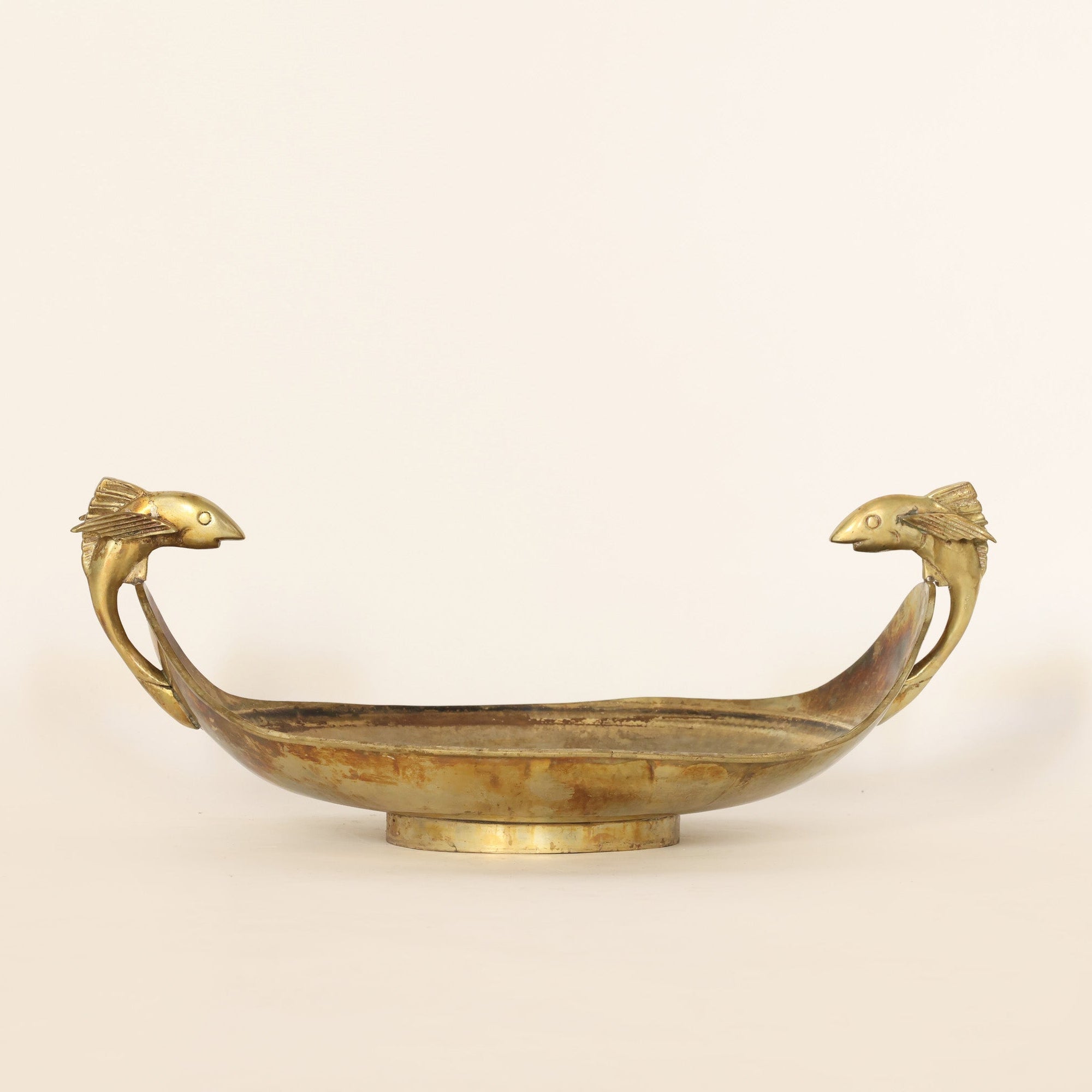 vintage brass centerpiece bowl on a beige background