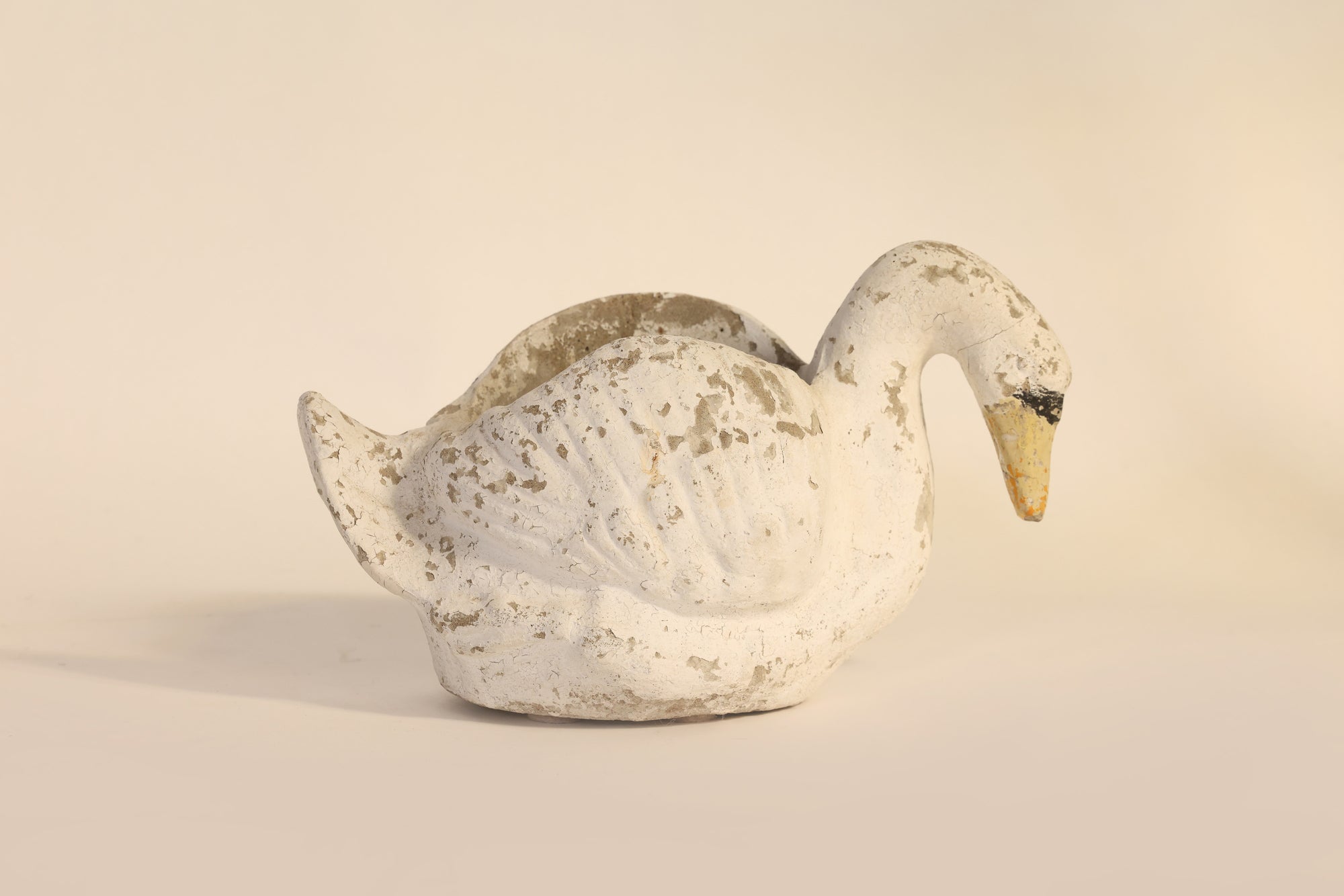 Decorative swan figure on a beige background