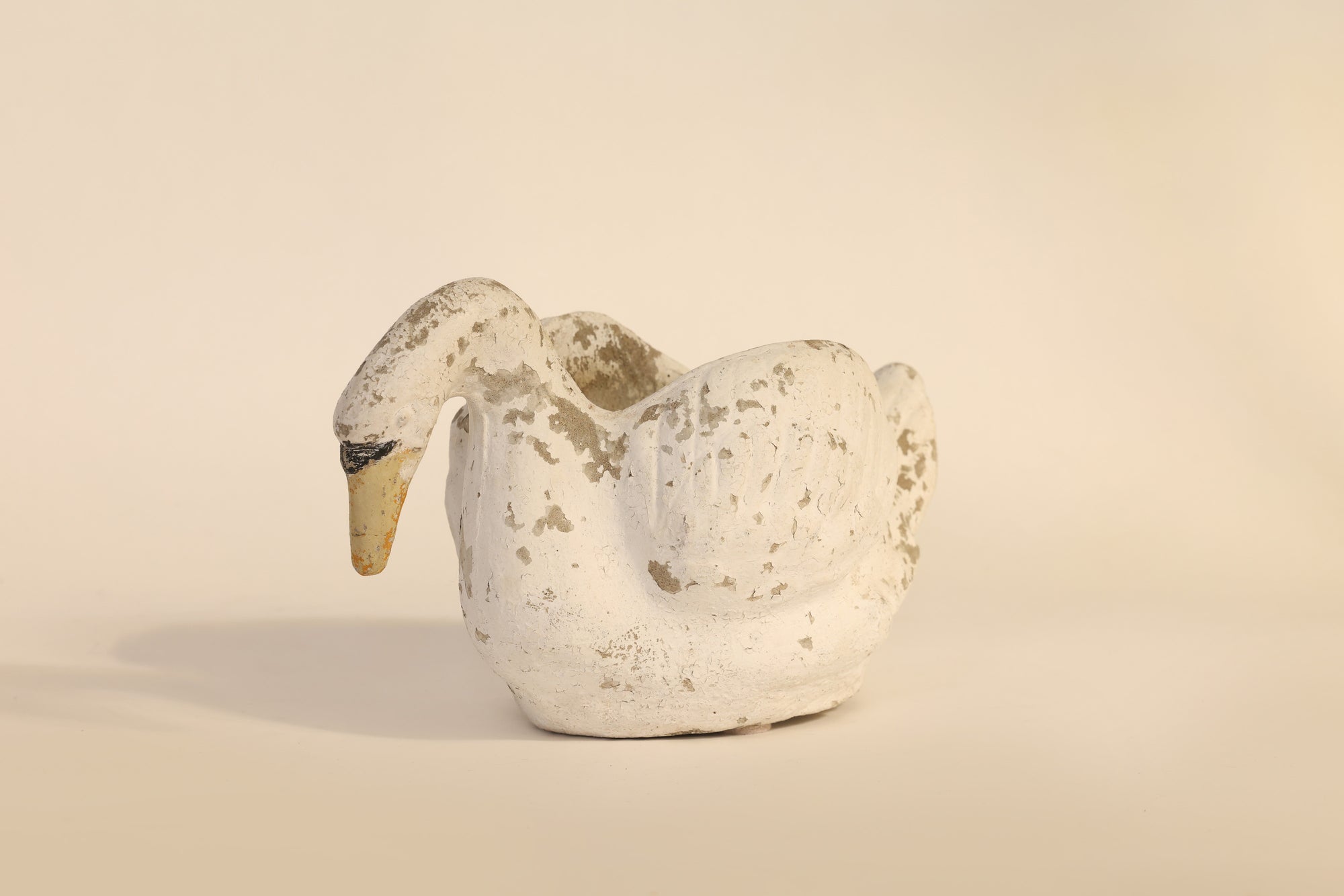 Decorative swan figure on a beige background