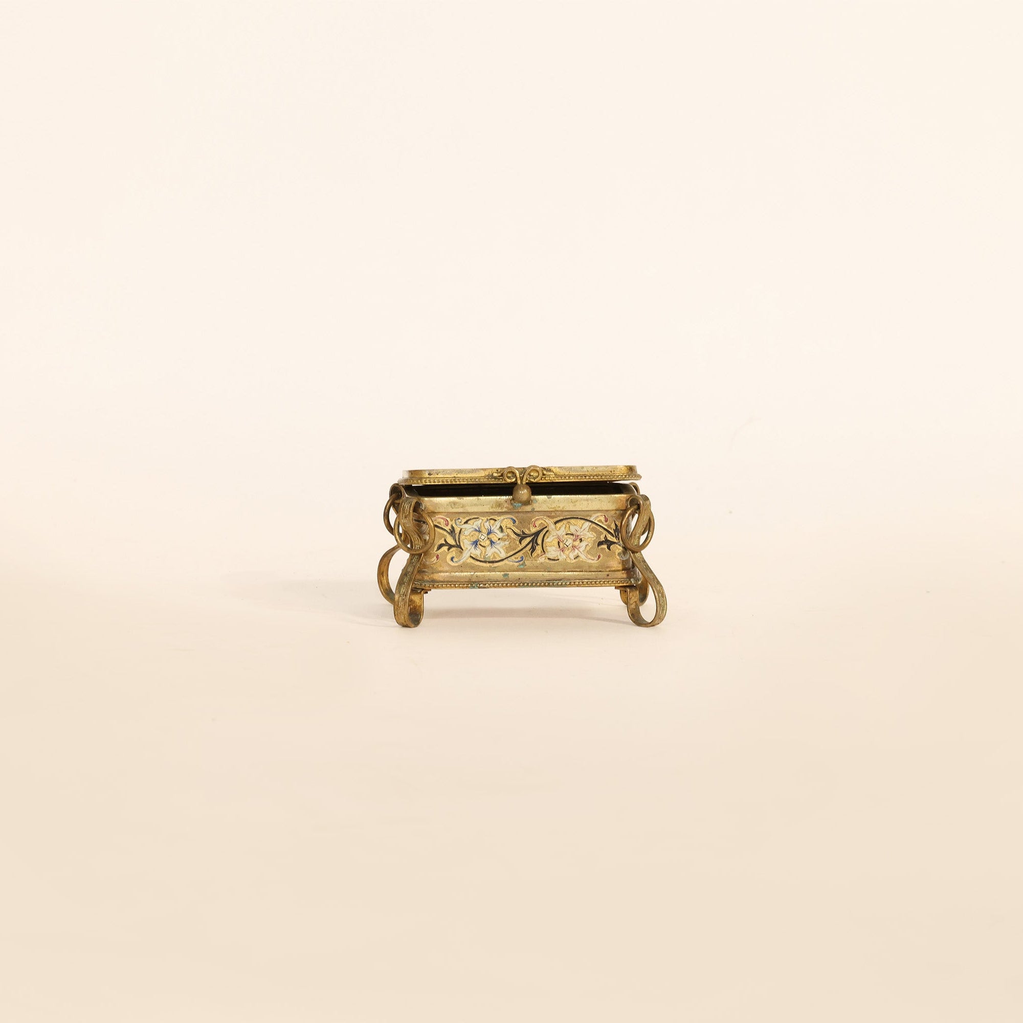 Decorative gold metal box on a beige background