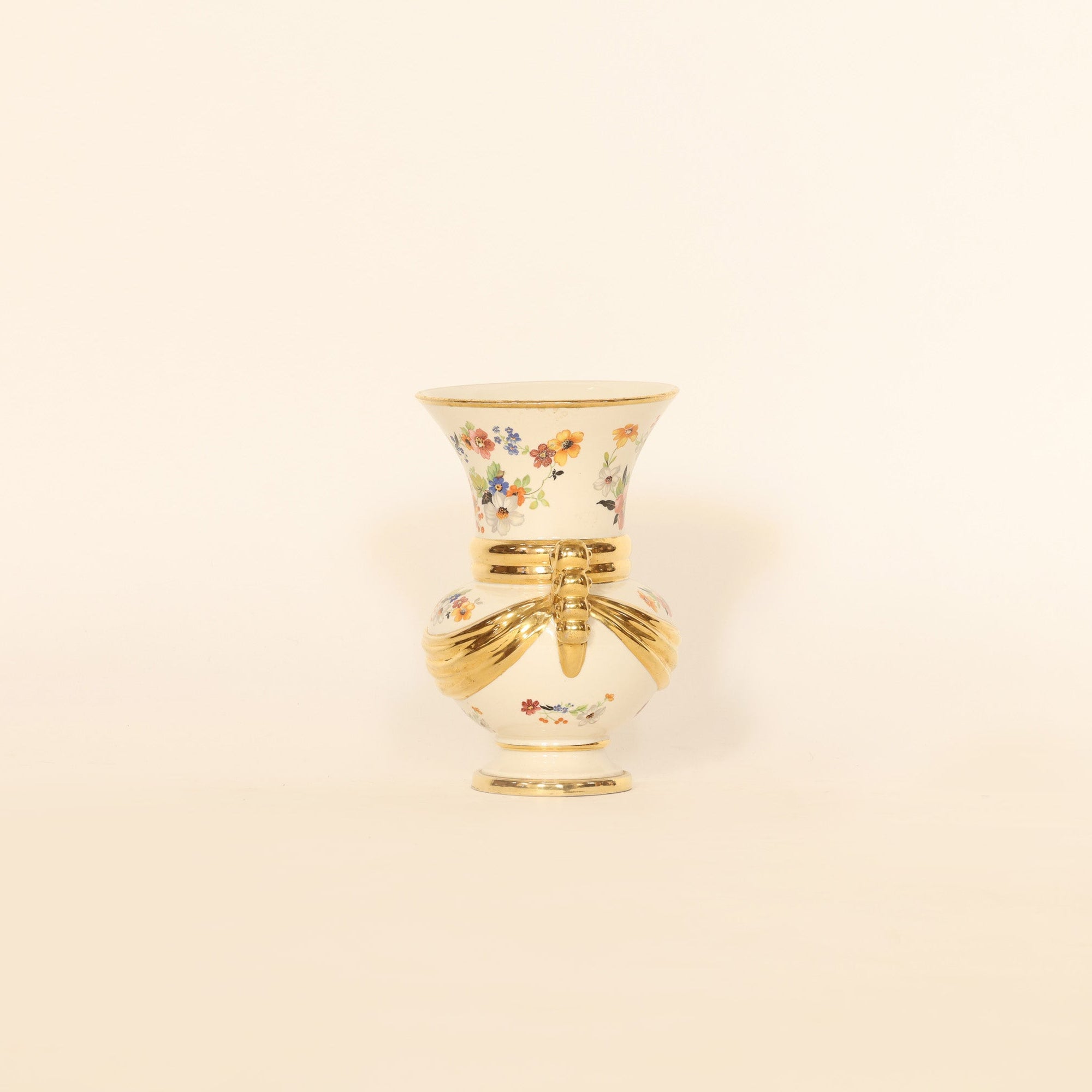 Decorative vase with floral design on a beige background
