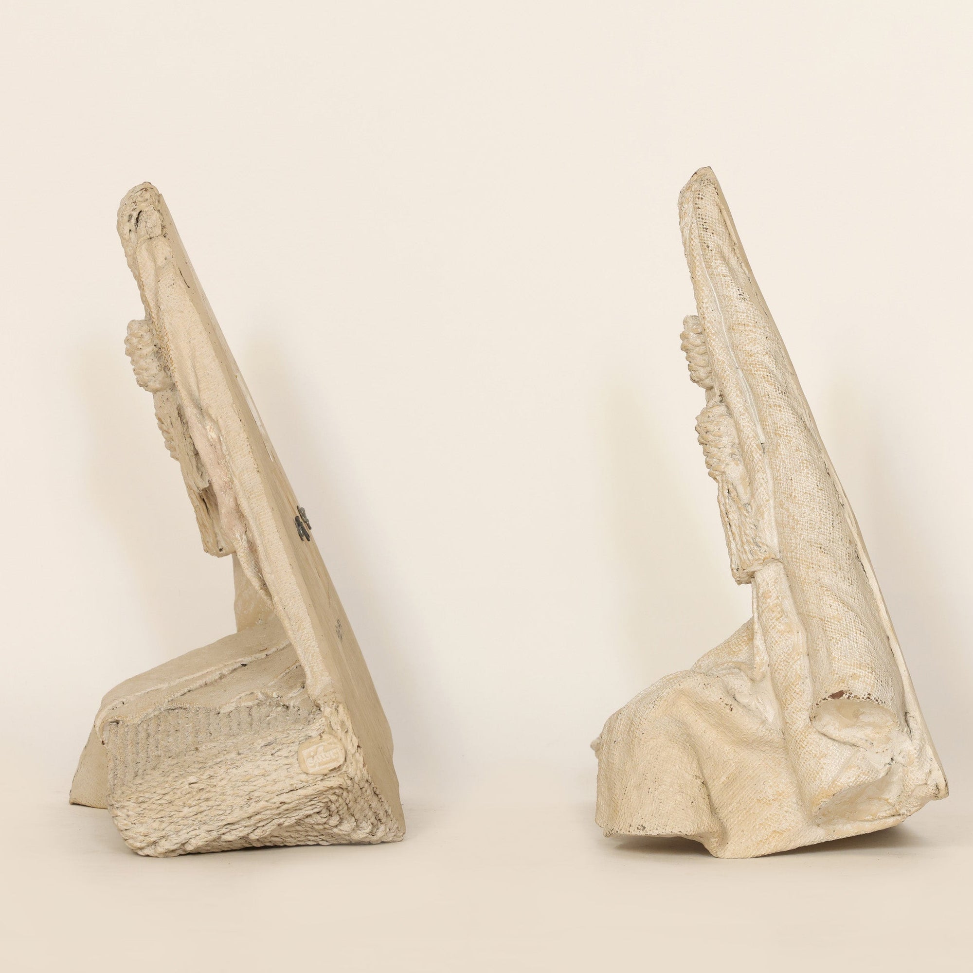 Two stone wall decorations on a beige background