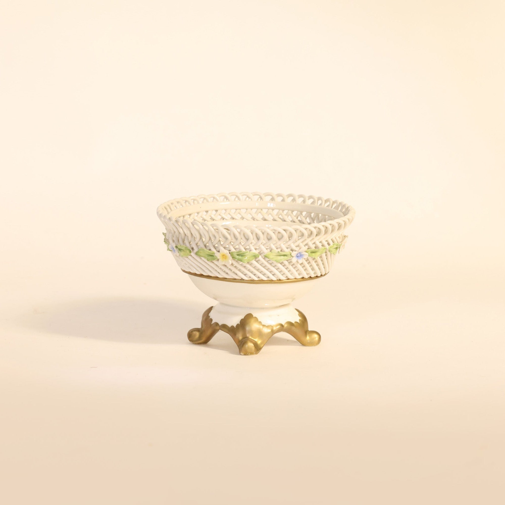 antique porcelain compote with floral patterns on beige background