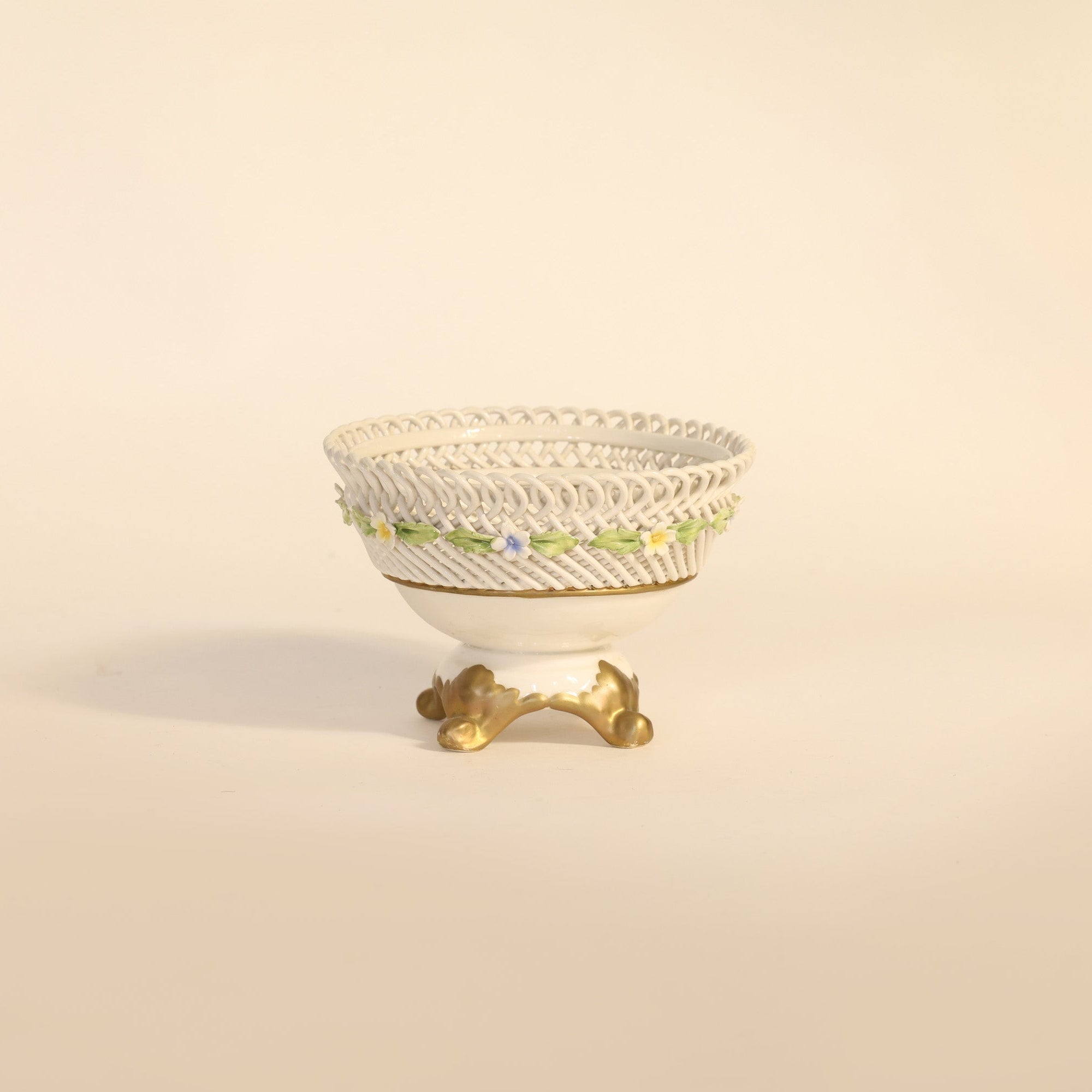 antique porcelain compote with floral patterns on beige background