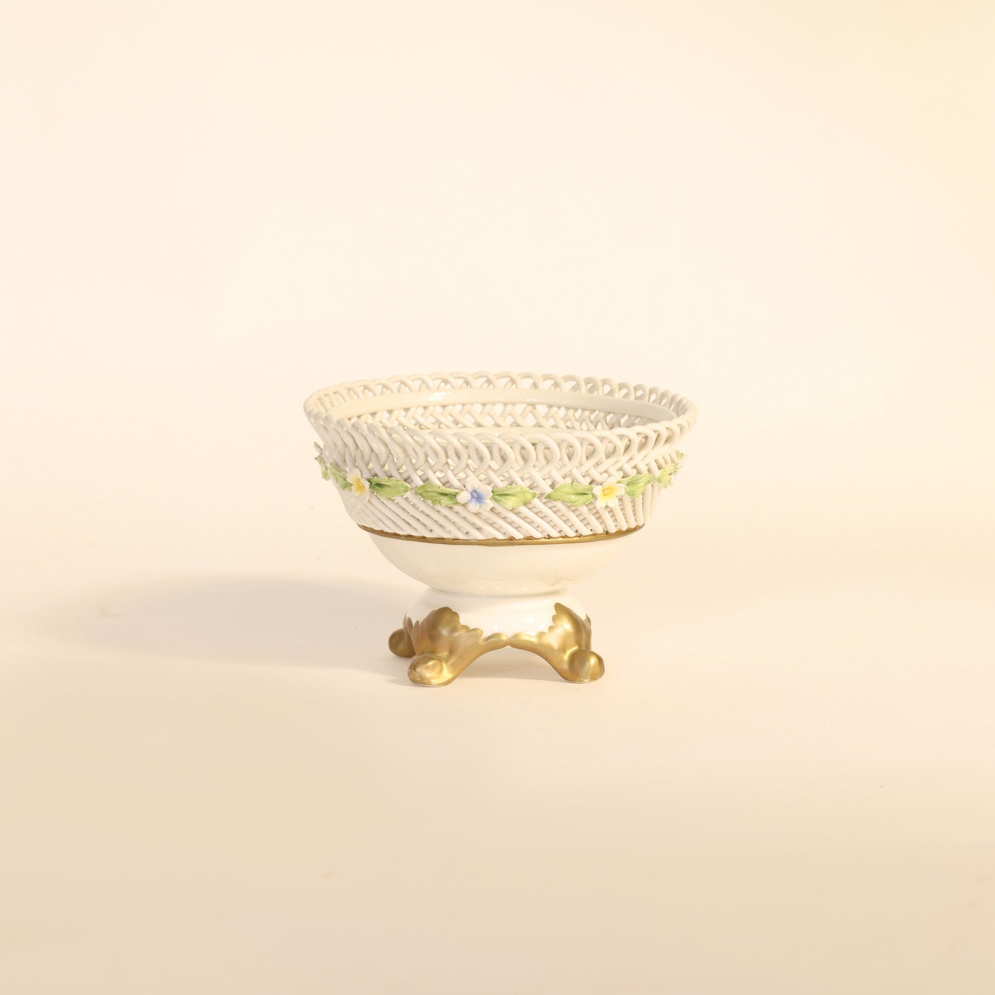 antique porcelain compote with floral patterns on beige background